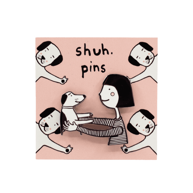 A cute pin of a girl (black hair, a soft smile and rosy red cheeks) holding her dog up in an embrace.