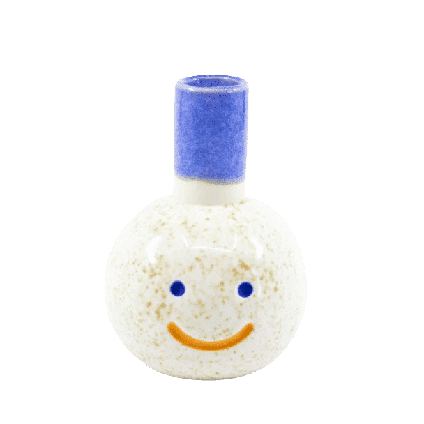 Benny is handmade by Shuh. He's a small vase with a blue skinny top for where flowers would be inserted & underneath are his blue cut out eyes and a happy orange mouth