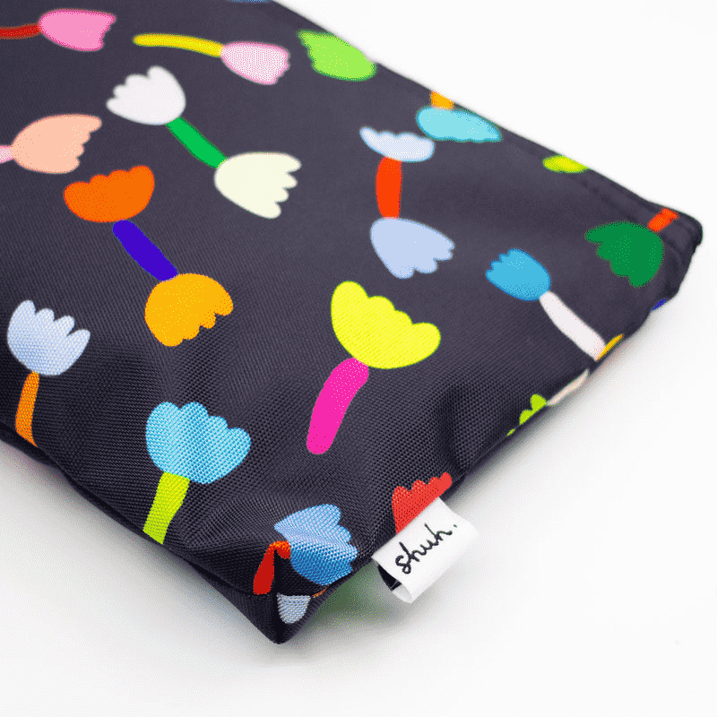 Shuh Lee's Tulip Useful Bag: A colourful print with a black background and multicoloured tulips scattered across the front and back.