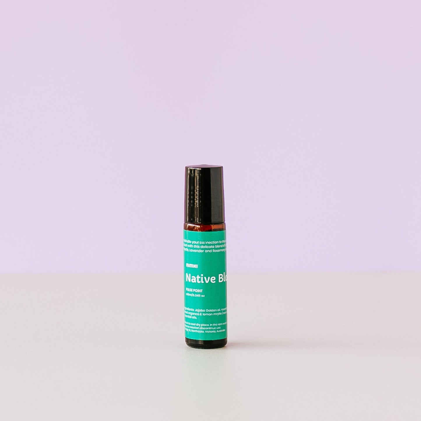 Nimki Native Bloom Natural Aromatherapy Perfume: A small roll on bottle with a forest green label that reeds "Nimki: Native Bloom Pulse Point"