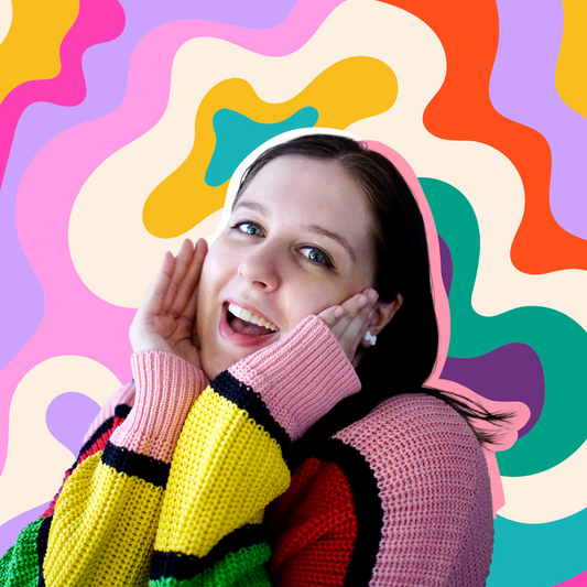 Emma, Owner of Fox & Cactus, smiling, cupping her face with a colourful swirl backdrop