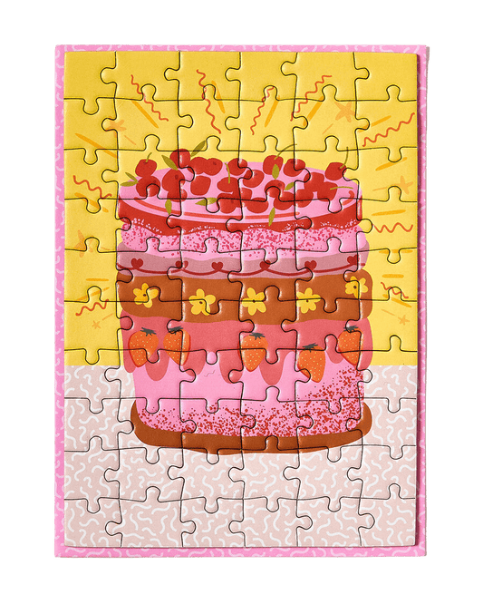 Greeting card puzzle: A super cute design of a multicoloured retro cake with flowers, strawberries and cherries on a yellow background with tiny squiggles around the outside. 