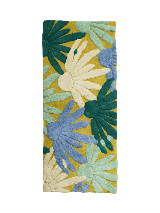 Margarita Bath Mat by Mosey Me. A long rectangular bath runner with blue, white and dark green half flowers with a pale green background. 