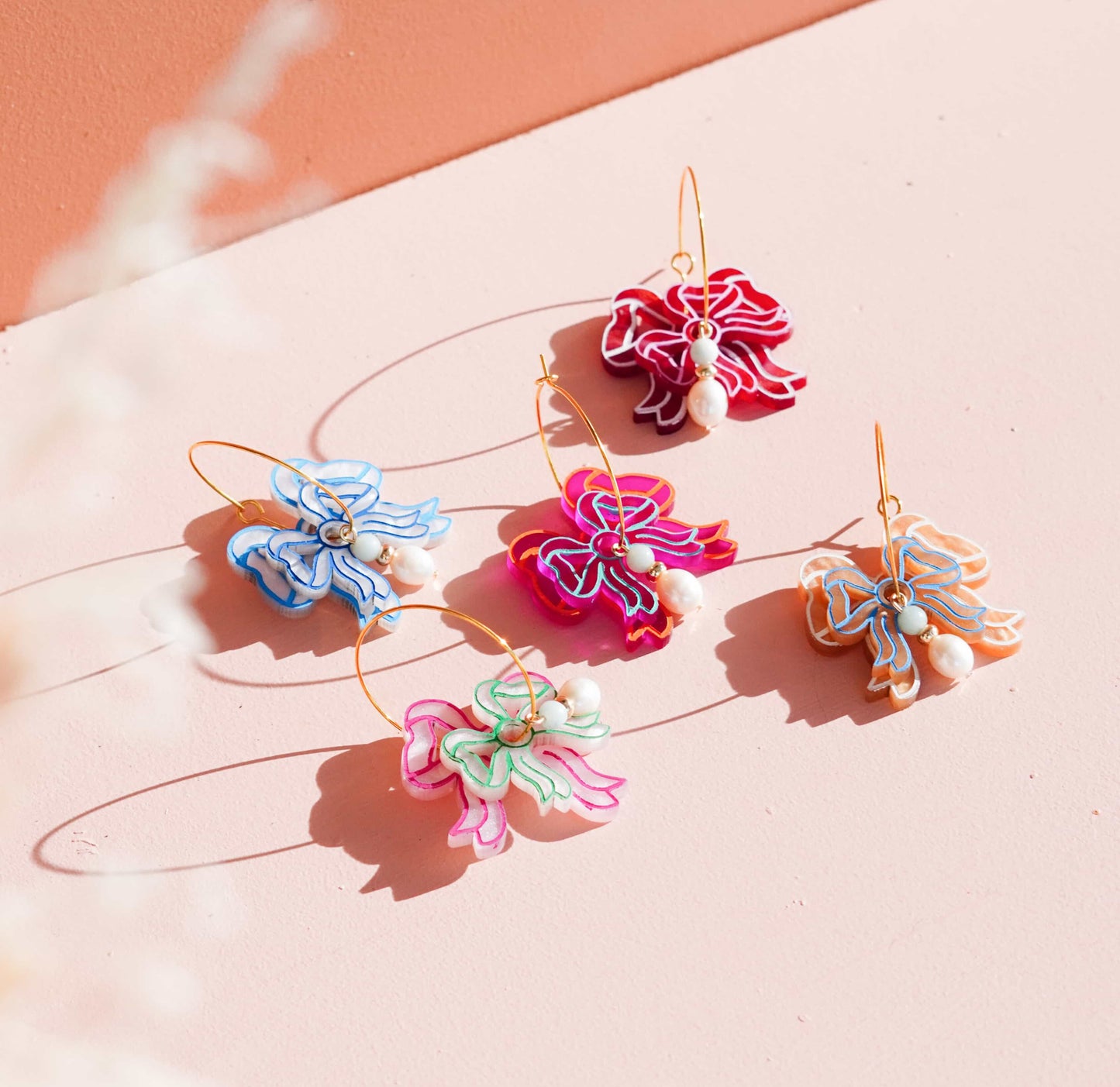 A collection of each coloured Bow Blossom Earrings by Flowature. 