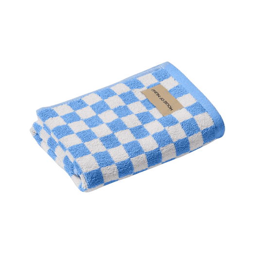 House of Nunu Blue Check Hand Towel: Folded into a perfect rectangle, this blue check hand towel features a white background with pastel blue checks. 