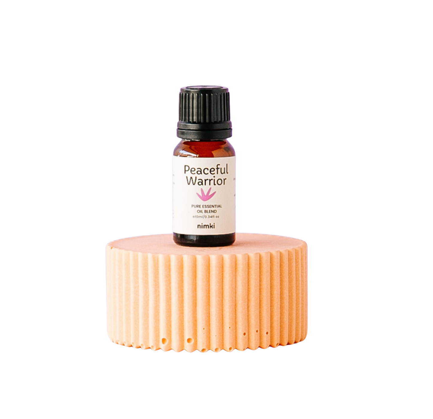 Nimki's Peaceful Warrior Essential Oil Blend on an orange plinth