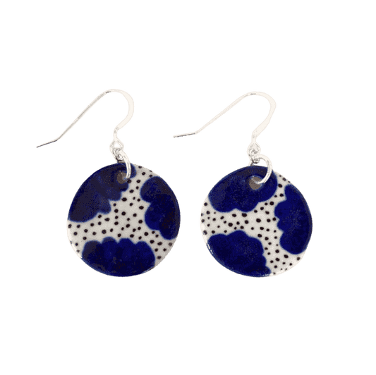 Shuh Lee Ceramic hook Earrings. These have blue, daisy like flowers in the corners and black speckles in the centre. 