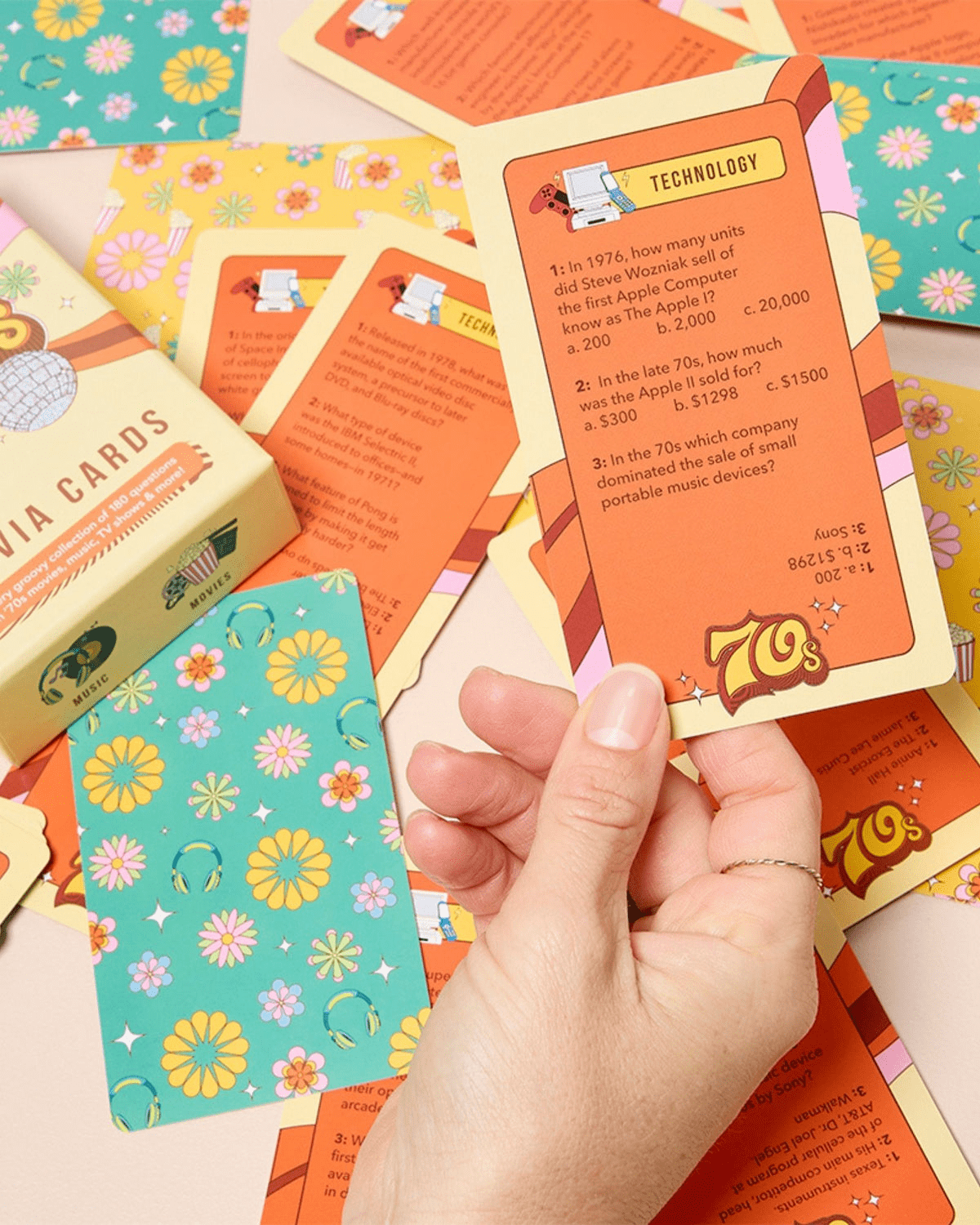 70's trivia cards by Journey of Something: A super cute deck of cards adorned with 70's references like disco balls, gogo boots, daisies and vinyl records around the number 70's. 
