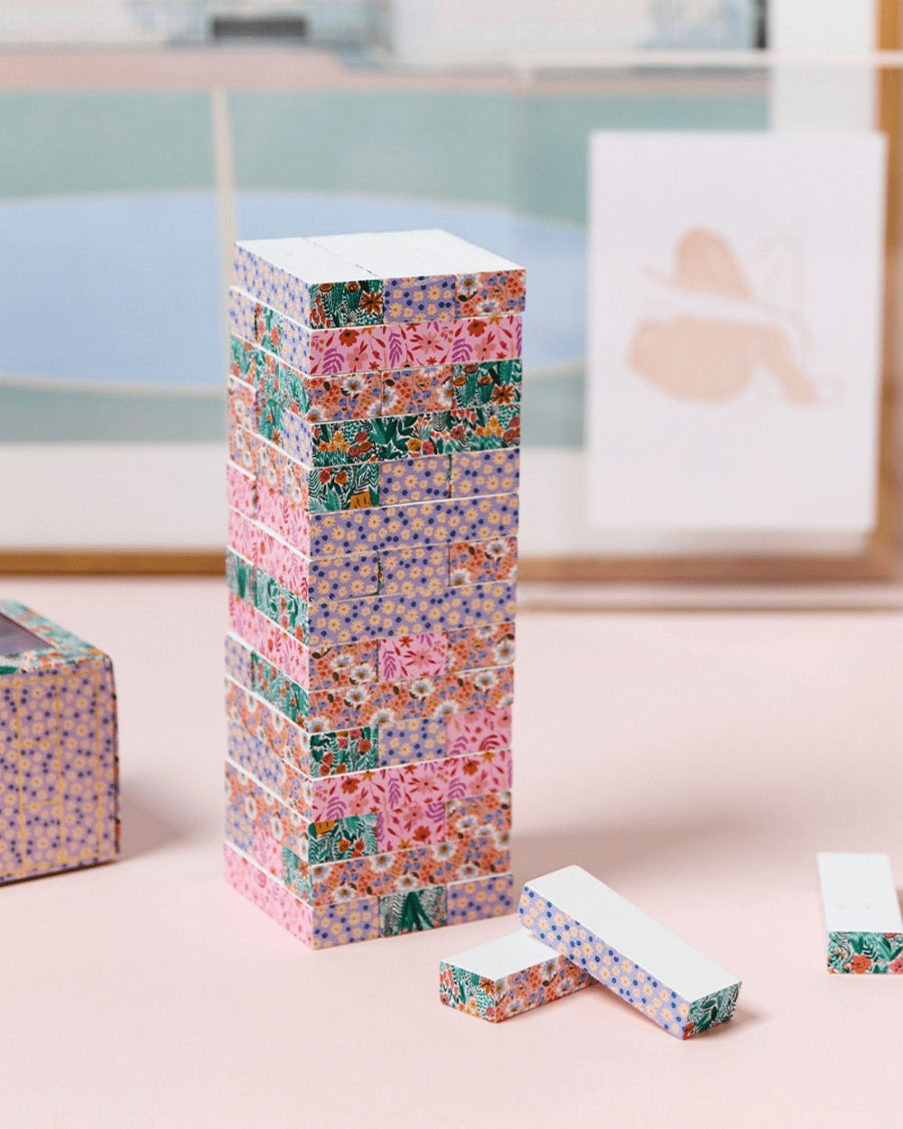 A gorgeous floral tumbling tower (AKA Janga) by Journey of Something. It features pink, red and orange delicate flowers and leaves. 