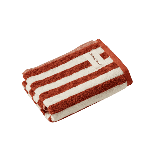A super cute hand towel by House of Nunu featuring red stripes on a white background. 